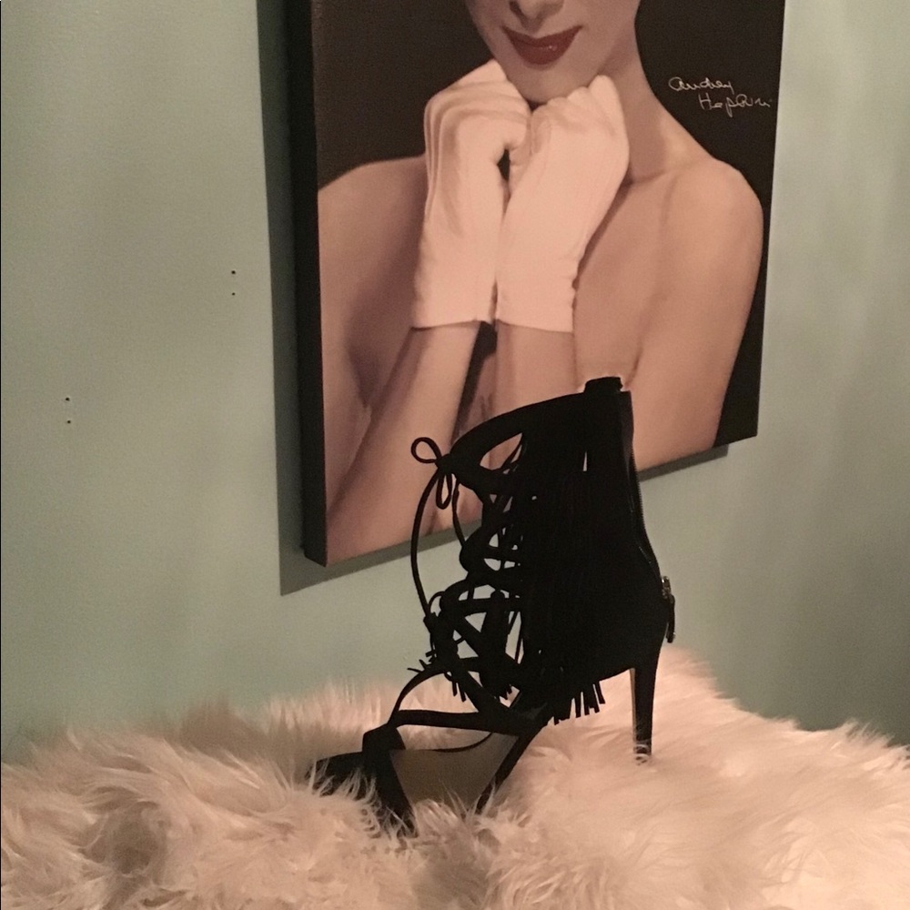 GUESS Slightly worn Strap up  fringe shoe.